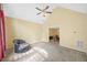 Bedroom with vaulted ceiling, ceiling fan, neutral carpet, and a view into the dining room at 8035 Canter Ln, Alpharetta, GA 30009