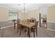 Dining room featuring neutral walls, carpet, trim, and furniture and a view into other rooms at 8035 Canter Ln, Alpharetta, GA 30009