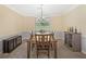 Dining room featuring neutral walls, carpet, trim, and furniture and a window overlooking greenery at 8035 Canter Ln, Alpharetta, GA 30009