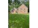 Charming brick two-story home with arched window and lush green lawn at 8035 Canter Ln, Alpharetta, GA 30009