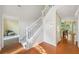 Spacious foyer featuring a staircase with white railings and hardwood floors and a view of other rooms at 8035 Canter Ln, Alpharetta, GA 30009