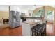 Bright kitchen with stainless steel appliances, granite countertops, white cabinets, and wooden floors at 8035 Canter Ln, Alpharetta, GA 30009