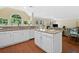 A kitchen island featuring granite countertops and stainless steel appliances next to a living room area at 8035 Canter Ln, Alpharetta, GA 30009
