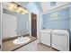 Laundry closet in the bathroom features side-by-side washer and dryer and a sink at 8035 Canter Ln, Alpharetta, GA 30009