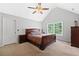 Spacious main bedroom features a ceiling fan, vaulted ceiling, carpet, and lots of sunlight at 8035 Canter Ln, Alpharetta, GA 30009