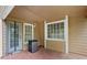 Covered patio with door and multiple windows providing an outdoor living space for relaxation and entertaining at 8035 Canter Ln, Alpharetta, GA 30009
