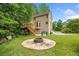 Backyard featuring a wooden deck with stairs, a fire pit and lush greenery at , Marietta, GA 30064