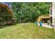 Spacious backyard featuring a wooden deck with stairs, a fire pit and lush greenery at , Marietta, GA 30064