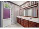 Bathroom featuring double sink vanity, medicine cabinet and bold wallpaper at , Marietta, GA 30064