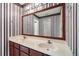 Well-lit bathroom featuring dual sinks, ample countertop space and striking striped wallpaper at , Marietta, GA 30064