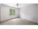Empty carpeted bedroom with white walls, ceiling fan and a window at , Marietta, GA 30064