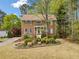 Beautiful two-story brick home with blue shutters, landscaped garden bed, and a inviting front entrance at , Marietta, GA 30064