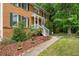 Inviting front entrance with white stairs, brick facade, and lush landscaping at , Marietta, GA 30064