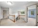 Upstairs hallway with wooden banister and doors that lead to carpeted rooms at , Marietta, GA 30064