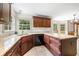 Spacious kitchen with granite countertops, dark wood cabinets, tile flooring, and stainless steel appliances at , Marietta, GA 30064