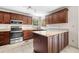 Modern kitchen with stainless steel appliances, granite counters, and wood cabinets at , Marietta, GA 30064