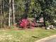Beautiful landscaped yard with vibrant azalea bushes and green grass, surrounded by mature trees at , Marietta, GA 30064