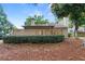 Backyard view showcases a wooded fence, landscaped hedges, and a glimpse of the home's exterior at 1104 Country Ct, Lawrenceville, GA 30044