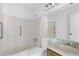 Bright bathroom features a built-in bathtub, tiled walls, and accessible grab bars for support at 1104 Country Ct, Lawrenceville, GA 30044