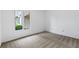 Bright bedroom featuring neutral carpet and view of greenery and siding through the window at 1104 Country Ct, Lawrenceville, GA 30044