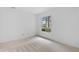 A bright, neutral bedroom featuring a window view with natural light and neutral carpeting at 1104 Country Ct, Lawrenceville, GA 30044