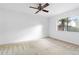Bedroom with neutral carpet, ceiling fan and view to the backyard at 1104 Country Ct, Lawrenceville, GA 30044