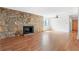 Inviting living room featuring a stone fireplace, hardwood floors, and abundant natural light at 1104 Country Ct, Lawrenceville, GA 30044