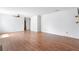 Open-concept living room with hardwood floors, ceiling fan, and neutral walls, creating a versatile space at 1104 Country Ct, Lawrenceville, GA 30044