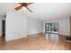 Expansive living area showcasing hardwood floors, a ceiling fan, and sliding glass doors to the patio at 1104 Country Ct, Lawrenceville, GA 30044