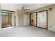 Bright sunroom featuring neutral carpet, ceiling fan and sliding glass doors to the living room at 1104 Country Ct, Lawrenceville, GA 30044