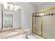 Well-maintained bathroom featuring granite vanity and a shower with sliding glass doors at 130 Robin Rd, Marietta, GA 30067