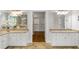 Bright bathroom featuring double vanities with granite countertops, mirrors, and an open walk-in closet at 130 Robin Rd, Marietta, GA 30067