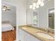 Spacious bathroom featuring double vanities with granite countertops, mirrors, and an adjoining bedroom at 130 Robin Rd, Marietta, GA 30067