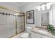 Bright bathroom featuring a tub/shower combo with gold trim and granite countertops at 130 Robin Rd, Marietta, GA 30067