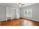 Bedroom featuring hardwood floors, built-in shelving and drawers, and a large window at 130 Robin Rd, Marietta, GA 30067