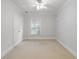 Bright bedroom features neutral carpet, white trim, a window, and a closet with double doors at 130 Robin Rd, Marietta, GA 30067