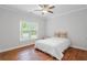 Cozy bedroom with hardwood floors, a queen bed, and a large window at 130 Robin Rd, Marietta, GA 30067