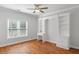 Bright bedroom featuring hardwood floors, built-in shelving and drawers, and a large window at 130 Robin Rd, Marietta, GA 30067