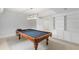 Spacious game room with a pool table, carpet flooring, white built-in shelving, and recessed lighting at 130 Robin Rd, Marietta, GA 30067