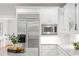 Close-up of kitchen featuring stainless steel appliances, white cabinets, and granite countertops at 130 Robin Rd, Marietta, GA 30067