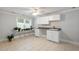 Well-lit laundry room with a window, white cabinetry, countertop, sink, and ceramic tile flooring at 130 Robin Rd, Marietta, GA 30067