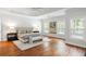 Main bedroom featuring a tray ceiling, hardwood floors, and many windows at 130 Robin Rd, Marietta, GA 30067