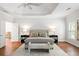 Light-filled main bedroom with tray ceiling, wood floors, and a sitting area at 130 Robin Rd, Marietta, GA 30067