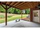 Covered patio with a concrete floor, bench seating, brick exterior, and view of the backyard at 130 Robin Rd, Marietta, GA 30067