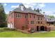 Large brick home with many windows, a deck, a walkout basement, a two-car garage, and a green lawn at 130 Robin Rd, Marietta, GA 30067