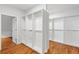 Spacious walk-in closet with custom shelving and hardwood floors in a modern home at 130 Robin Rd, Marietta, GA 30067