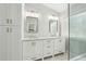 Bathroom featuring double vanities, white cabinets and a seamless glass shower at 3694 Lambert Ne Ln, Atlanta, GA 30319