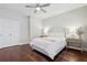 A bedroom with hardwood floors, ceiling fan, and a bed flanked by two night stands at 3694 Lambert Ne Ln, Atlanta, GA 30319