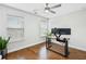 Bedroom with hardwood floors, two windows, modern ceiling fan and a work space with desk and monitors at 3694 Lambert Ne Ln, Atlanta, GA 30319