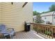 A wooden deck with a grill and Adirondack chair looks out over a lawn at 3694 Lambert Ne Ln, Atlanta, GA 30319